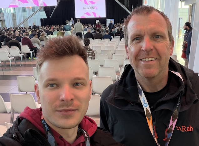 Two team members from a Craft CMS agency standing inside the Laracon EU conference venue